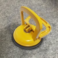 Extracteur d'aspiration par aspiration sous vide, avec une ventouse, pour le levage de carreaux de verre