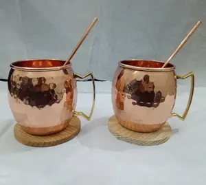 Juego de tazas de cobre, dos posavasos de madera y un vaso corto