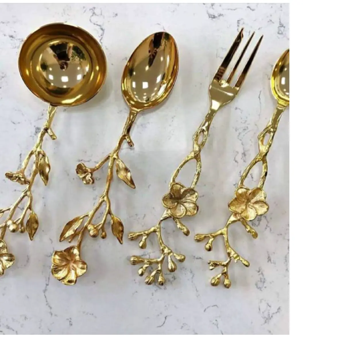 custom made brass cutlery sets including brass spoons,fork and knives in gold finish in leaf & floral design suitable for home.