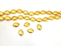 Perles ovales en cuivre gravées fantaisie plaquées or 14x10mm