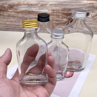Bouteille en verre transparente vide pour liqueur, bouteille en verre ronde plate pour jus, emballage de bouteille avec logo imprimé personnalisé, vente en gros