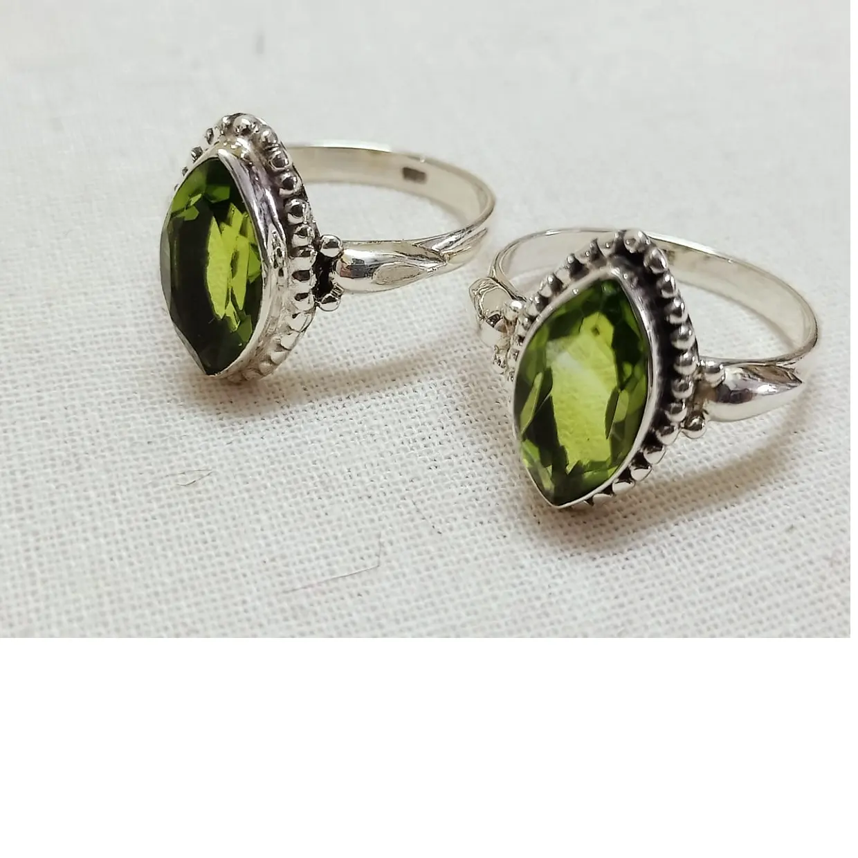 custom handmade silver finger rings with synthetic peridot stones suitable for fashion jewelry stores